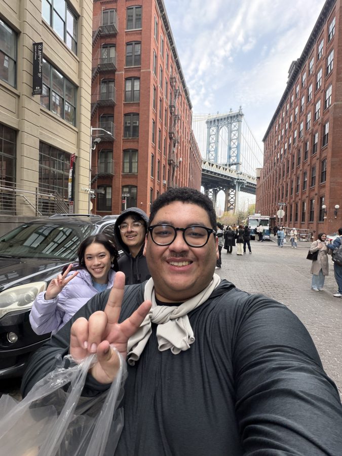 Jorell and friends on a Brooklyn street with the Manhattan Bridge behind them